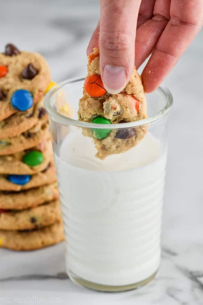 dipping the best monster cookie recipe into milk