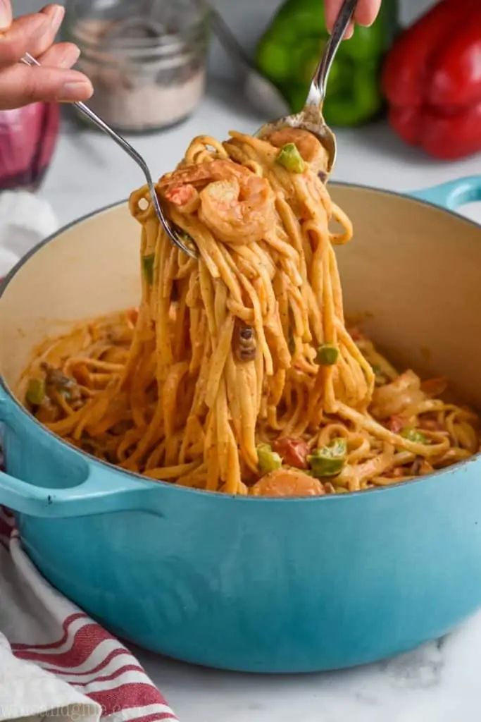 creamy one pot shrimp fajita pasta being pulled up out of the pot