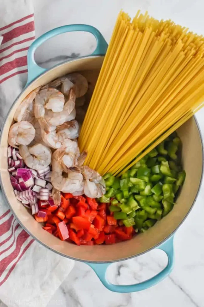 overhead view of one pot pasta with peppers, onions, shrimp, and noodles