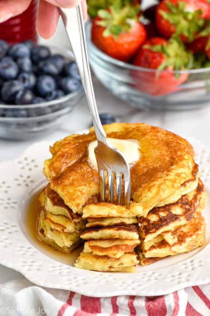 stack of yogurt pancakes with a cut made into them, and a fork digging in