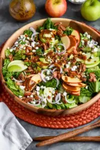 overhead view of apple bacon salad with goat cheese and nuts