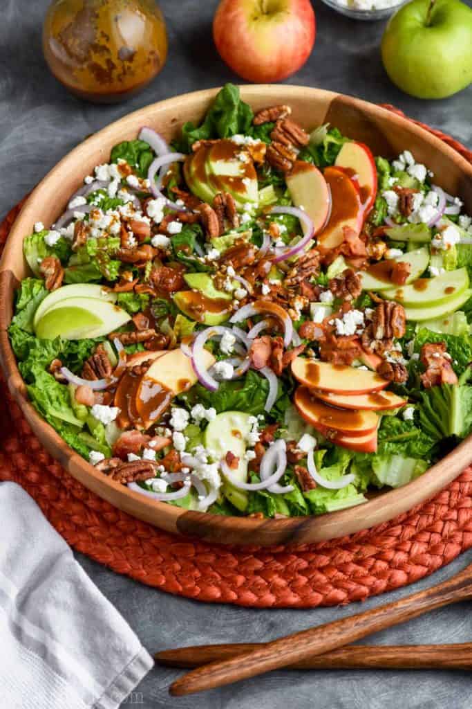 overhead view of apple bacon salad with goat cheese and nuts