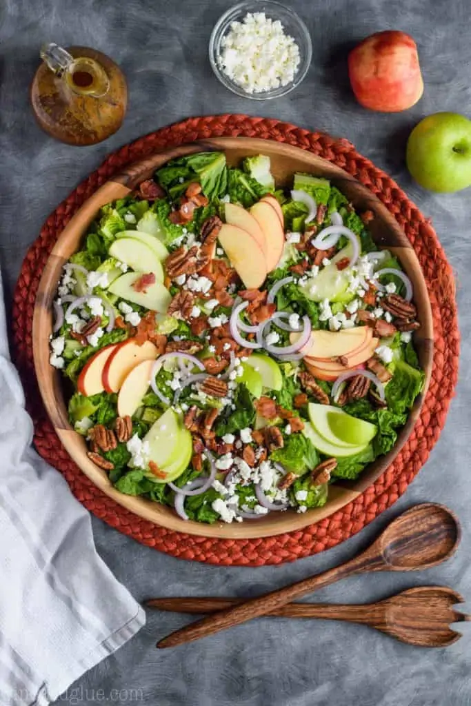 overhead view of apple bacon salad with goat cheese and nuts