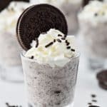 up close shot of a cookies and cream pudding shot garnished with whipped cream and an oreo cookie - 4