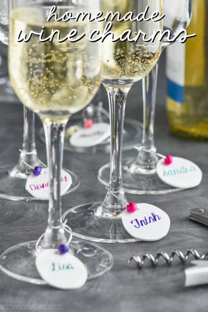 diy wine charms hanging off of champagne glasses