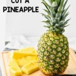 a whole pineapple on a cutting board waiting t be cut