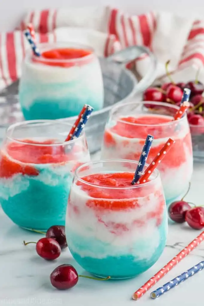 layered wine slushies with red, white, and blue for fourth of july cocktail