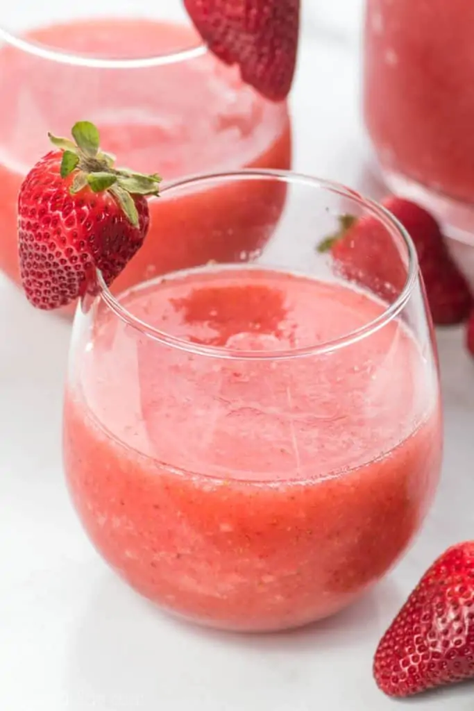 glasses of Strawberry Wine Slushies with a slice of strawberry on the glass