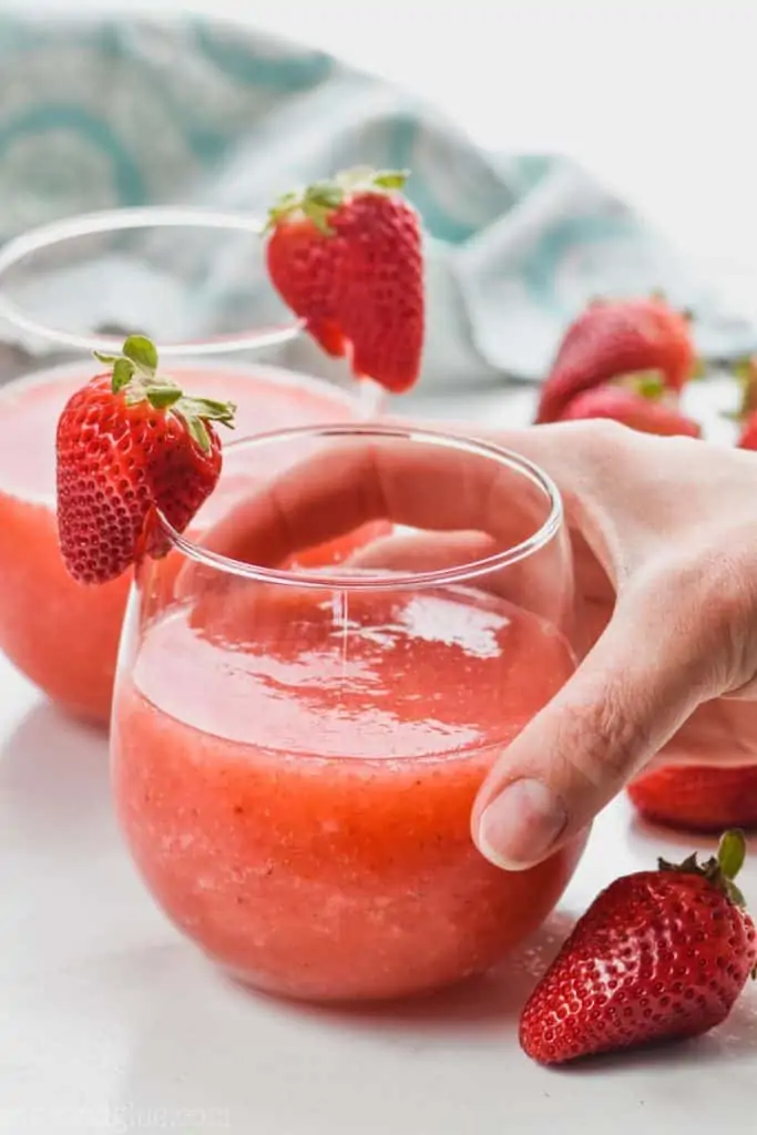 hand hold a glass of frozen wine slush