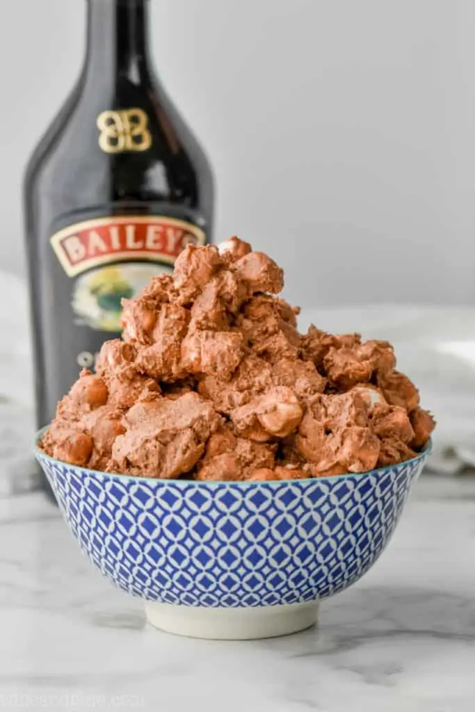 big bowl of baileys fluff salad with bottle of baileys in the background