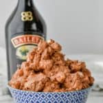 big bowl of baileys fluff salad with bottle of baileys in the background