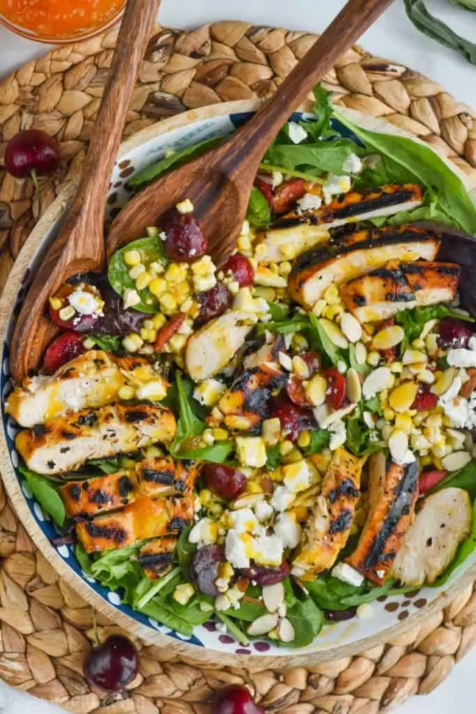 overhead photo of cherry and easy corn salad recipe with grilled chicken and cheese