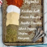 Pinterest graphic of overhead of a baking tray with piles of spices labeled that make up cajun seasoning