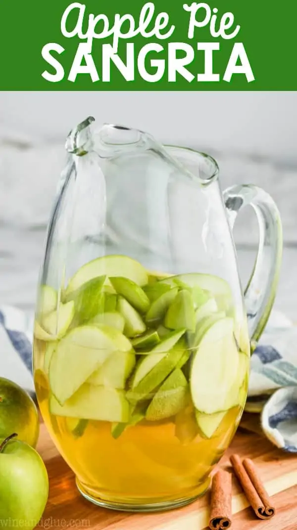 A pitcher with sliced green apples and Apple Pie Sangria