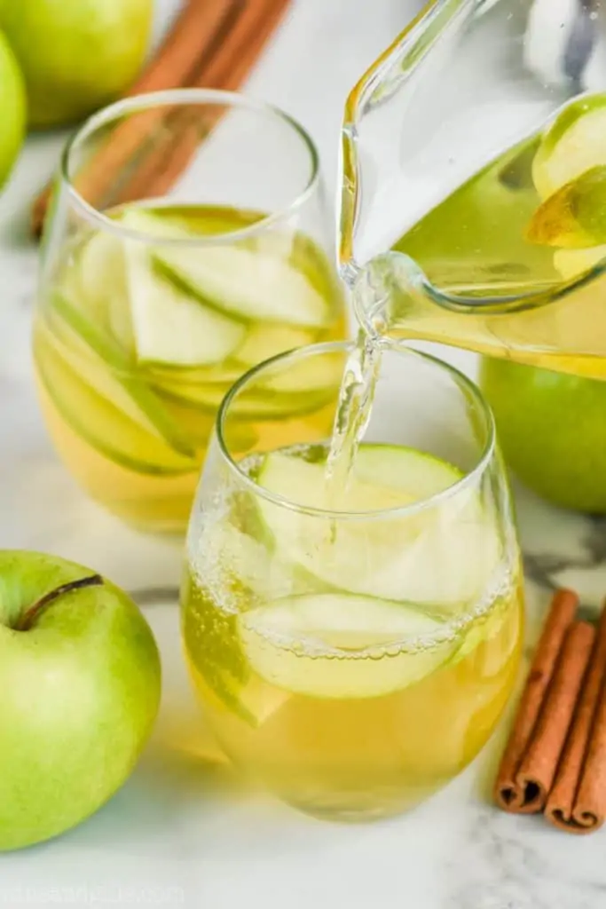 apple pie sangria recipe being poured into a glass