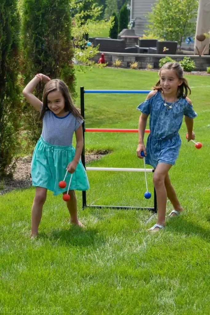 two kids play ladder ball