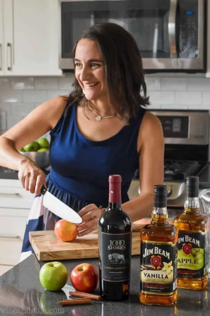 woman cutting up an apple for apple pie sangria