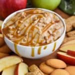 bowl of caramel apple dip recipe dripping from the sides with caramel sauce - 5