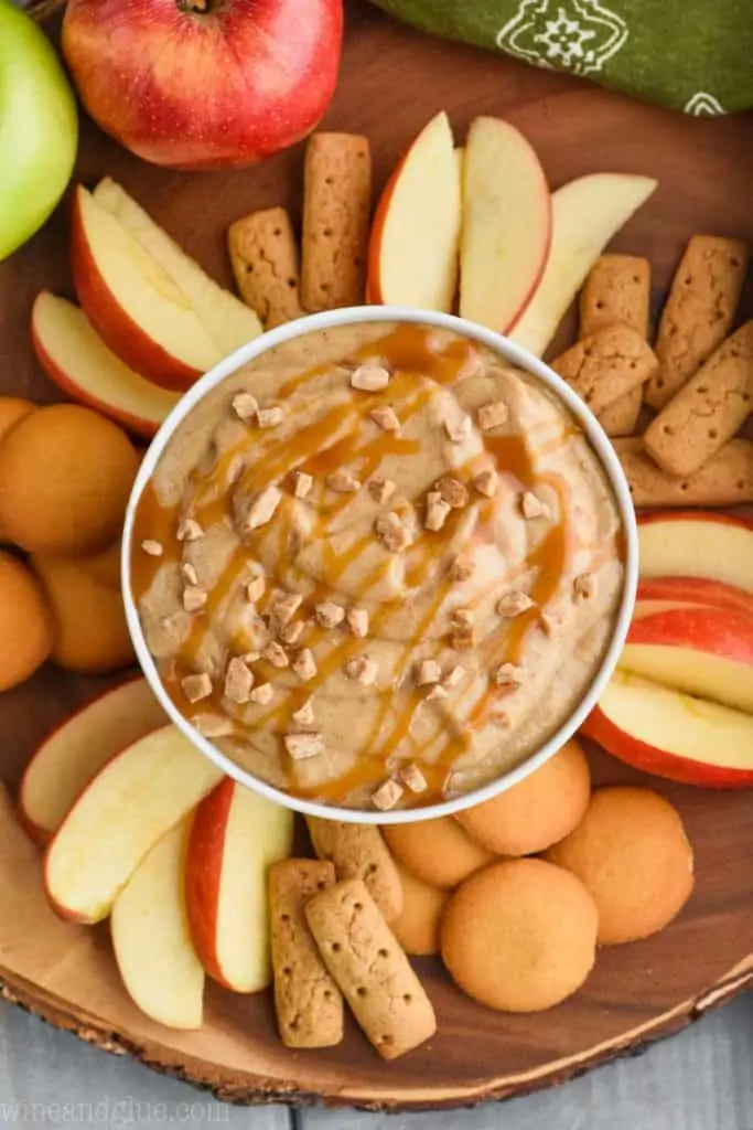 overhead view of caramel apple dip recipe with apples, cookies and crackers 