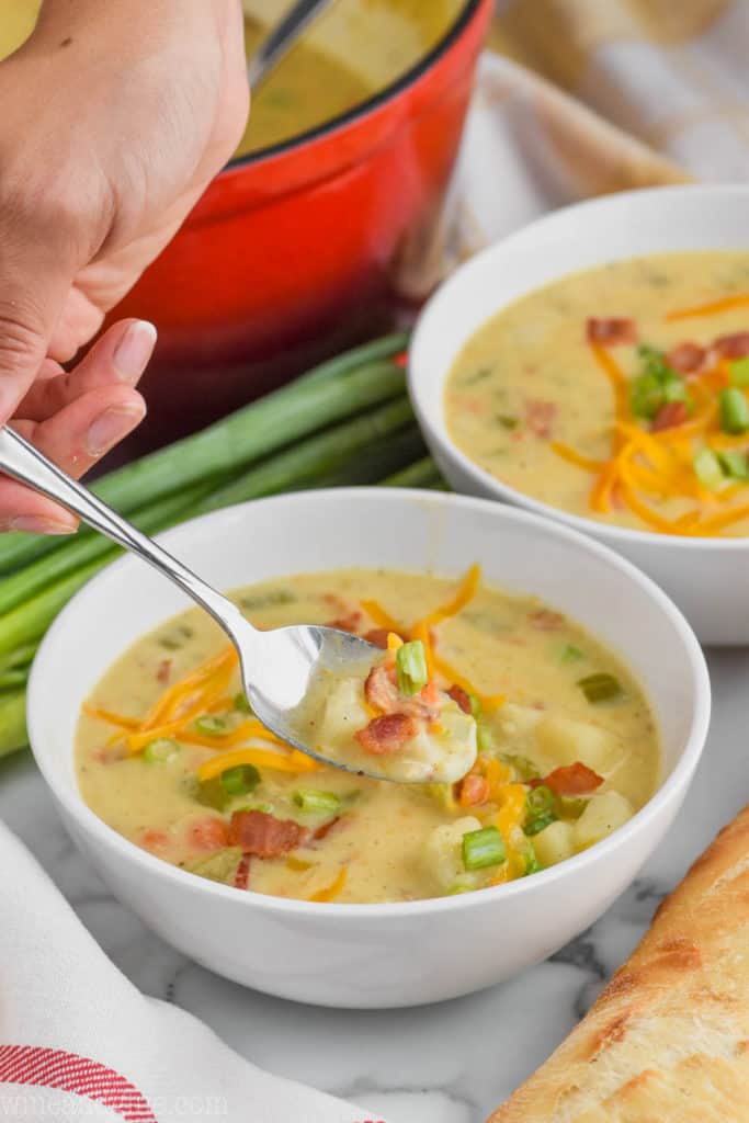 easy creamy potato soup recipe being spooned out of a bowl