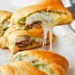 dishing out a piece of philly cheese steak crescent ring