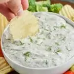 up close of chip being dipped into dill dip recipe