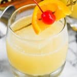 the best whiskey sour recipe garnished with an orange and cherry