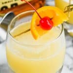 the best whiskey sour recipe garnished with an orange and cherry