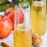 champagne pouring into a glass of bellini drink recipe - 17