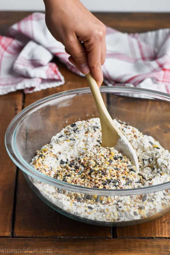stirring together the ingredients for a bird feeder