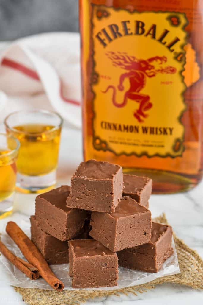 pile of condensed milk fireball fudge recipe with a bottle of fireball whiskey
