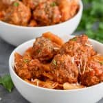 close up of a white bowl of pressure cooker meatballs and pasta garnished with parsley - 8