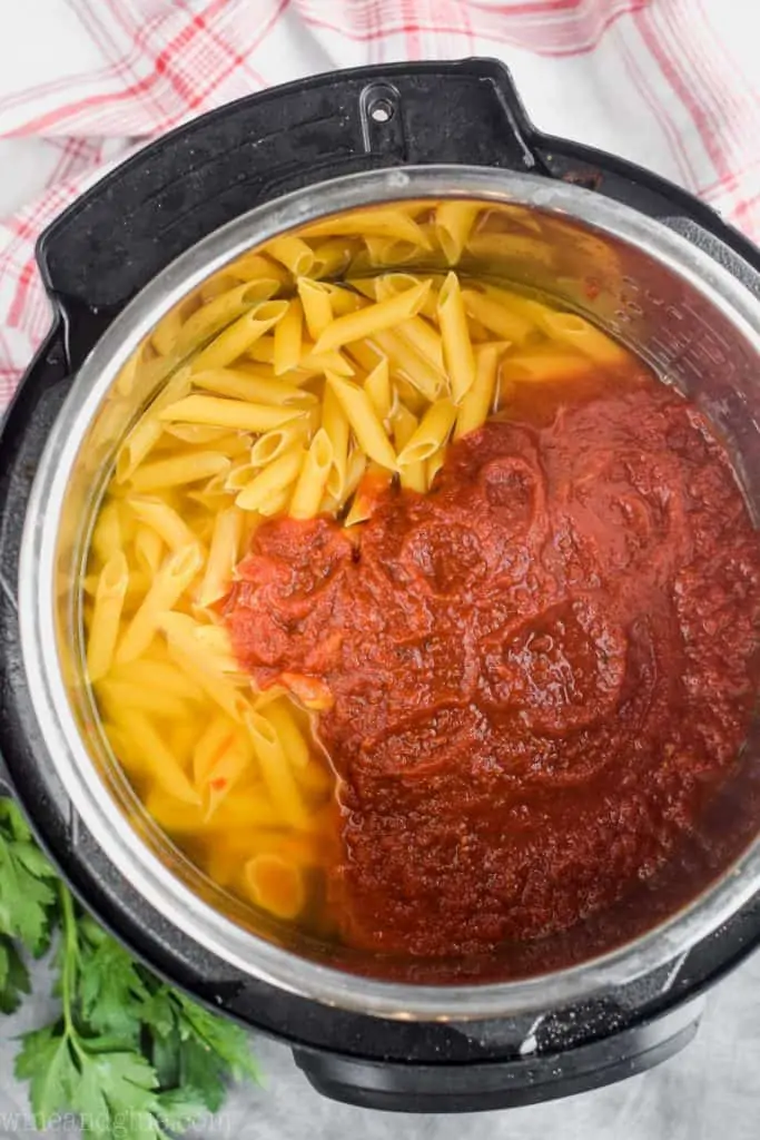 overhead view of pasta and spaghetti sauce in a pressure cooker
