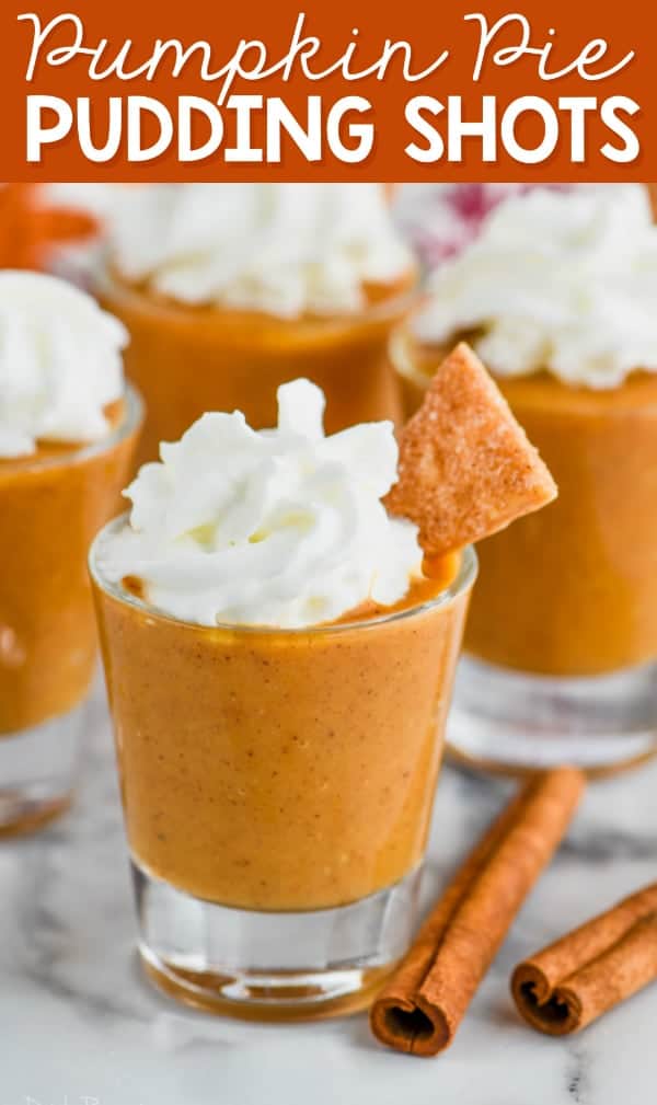 shot glass full of pumpkin pie shot topped with whipped cream and pie crust