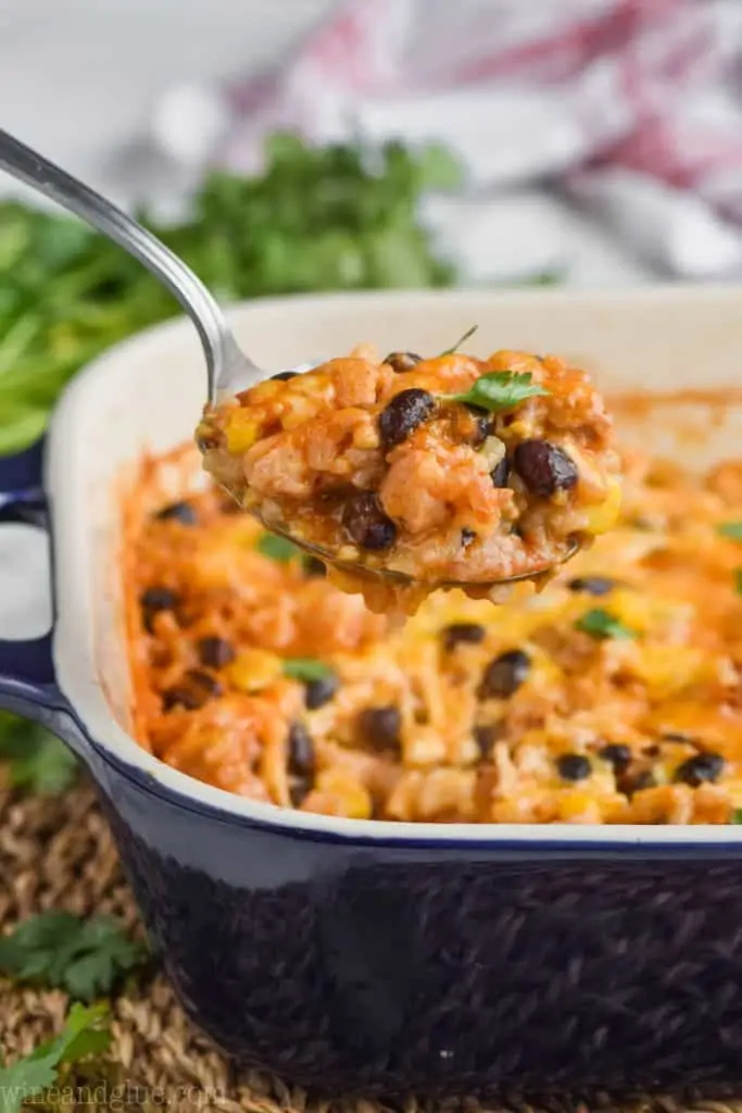 chicken and rice casserole recipes being spooned out of baking dish