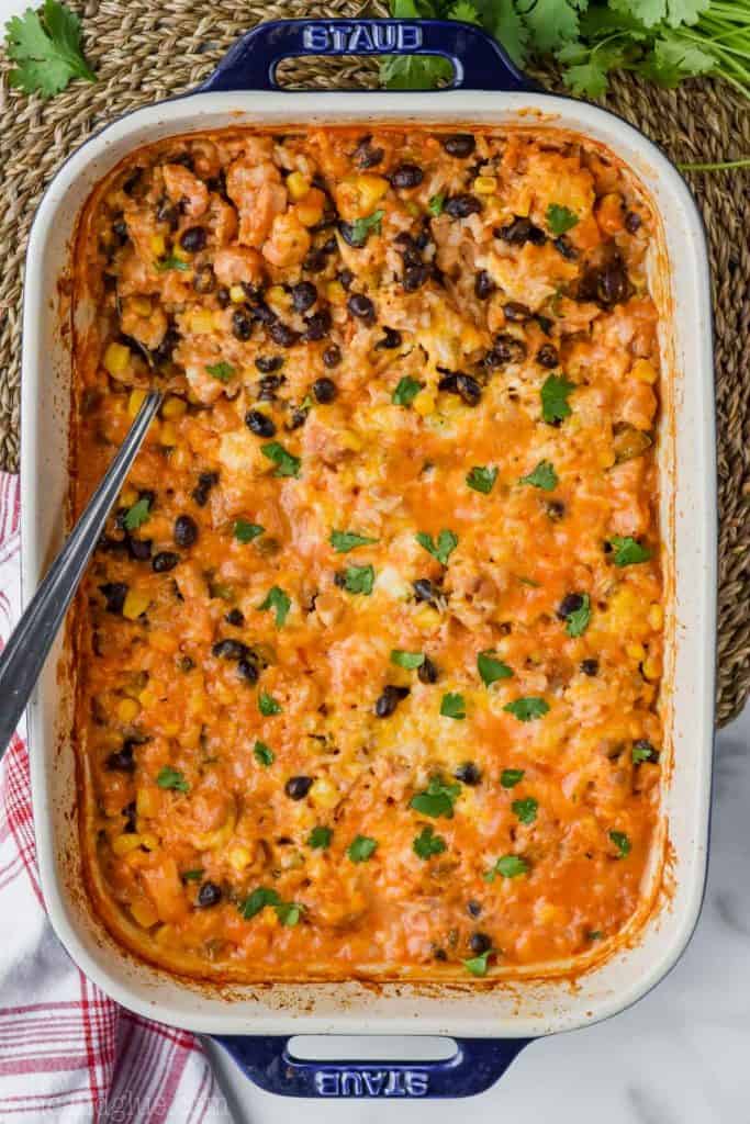 overhead of southwestern cheesy chicken and rice casserole in baking dish
