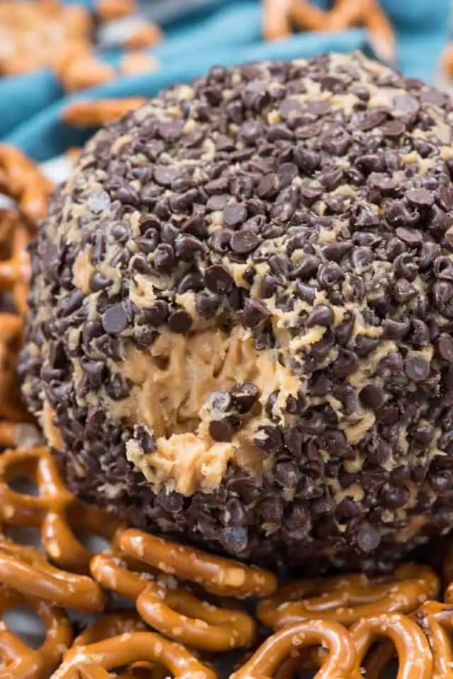 The Peanut Butter Cheese Ball Dip is surrounded by pretzels 