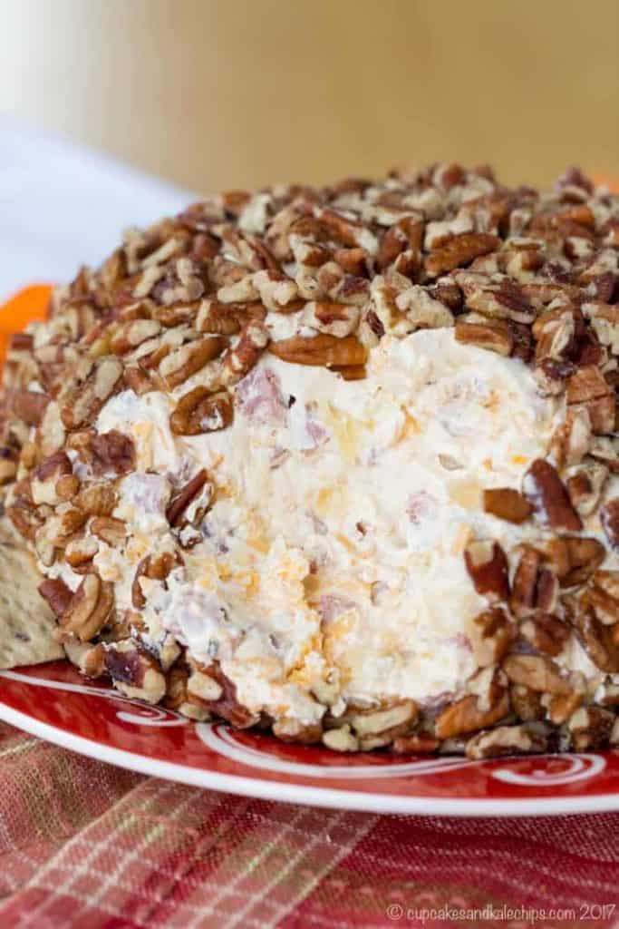 A close up photo of the Pineapple Ham Cheese Ball that is topped with Pecans. 