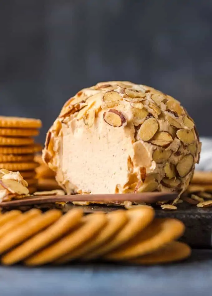 The classic cheese ball is topped with toasted almonds and surrounded by Ritz Crackers. 