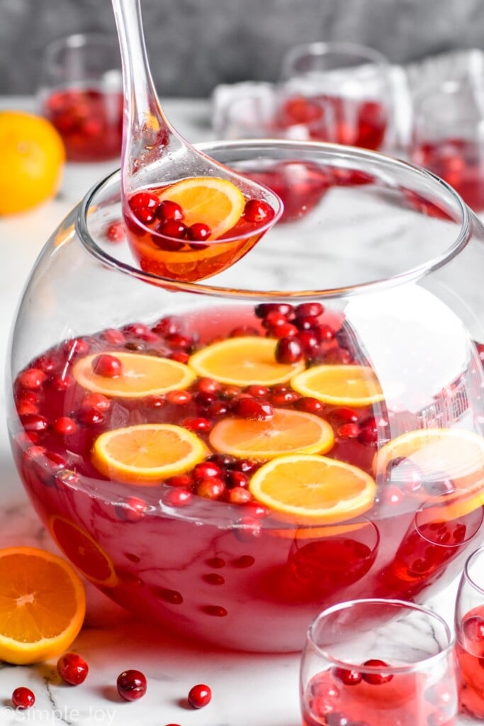 punch bowl full of christmas punch that is being ladled out