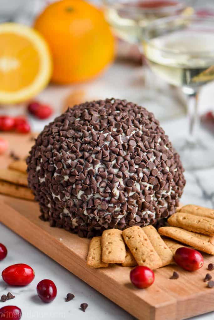 cranberry orange chocolate chip cheeseball on a cutting board with crackers