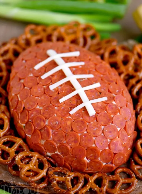 The Pepperoni Pizza Football Cheese Ball is surrounded by pretzels. 