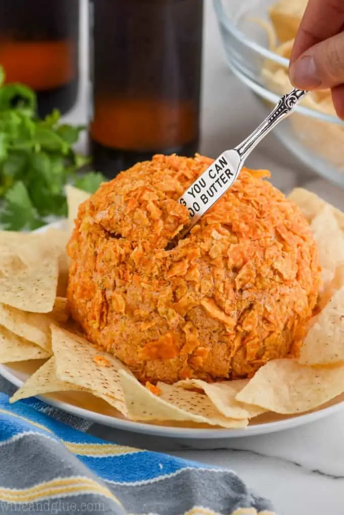 taco cheese ball with small knife sticking out of it for serving