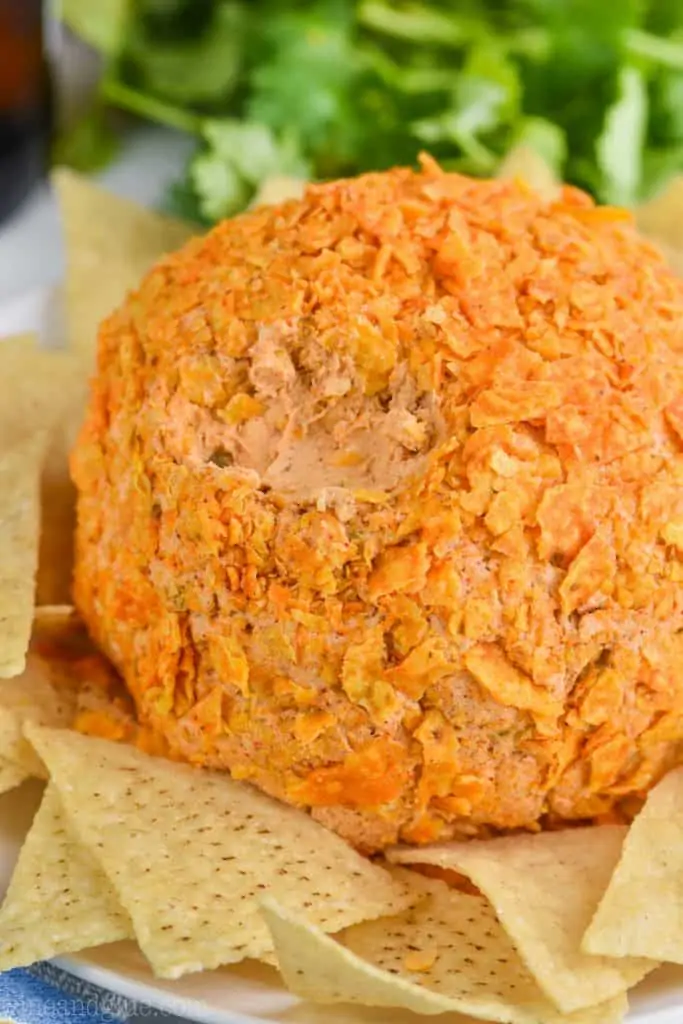 close up of taco cheese ball recipe covered in broken up Doritos