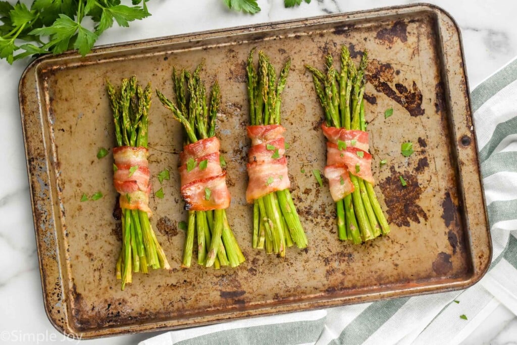 asparagus wrapped in bacon, on a bacon sheet