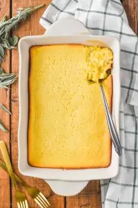 overhead of baked cream corn casserole in white casserole dish