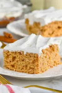 poke cake recipe with cool whip frosting on white plate