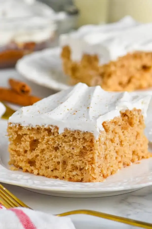 poke cake recipe with cool whip frosting on white plate