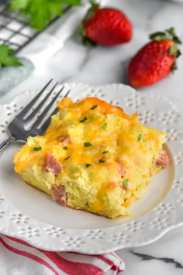 piece of ham and cheese overnight breakfast casserole on a white plate