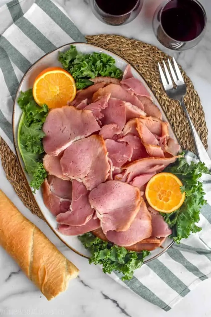 cut up ham on a platter that has been cooke din a slow cooker